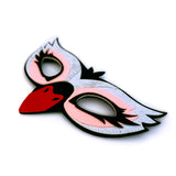 Close-up details of felt swan mask against white background with intricately cut layers of felt stitched together.