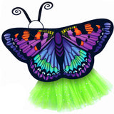 Exquisite butterfly cape costume set spread out against a clean white background with purple artemis-inspired patterned cape, green sparkle tutu, and black antennae headband. A wearable work of art!
