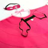 Close-up details of back or underneath side of flamingo cape showcasing black elastic shoulder straps for comfort and safe wearability