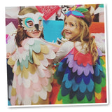 Two friends wearing charming bird capes striking a playful pose for a picture, showcasing their whimsical feathered ensembles in a delightful moment of friendship and fun.