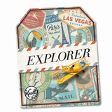 A small yellow vintage-style biplane attached to a decorative travel-themed card labeled "EXPLORER," with illustrated stamps and postmarks in Las Vegas, Paris, and other cities. The product is photographed on a plain white background.