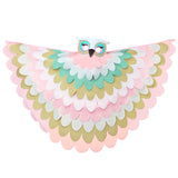 Pastel owl costume with fabric cape made from layers of pink, brown, white, and turquoise fabric and a felt bird mask set on a white background, perfect for a whimsical costume