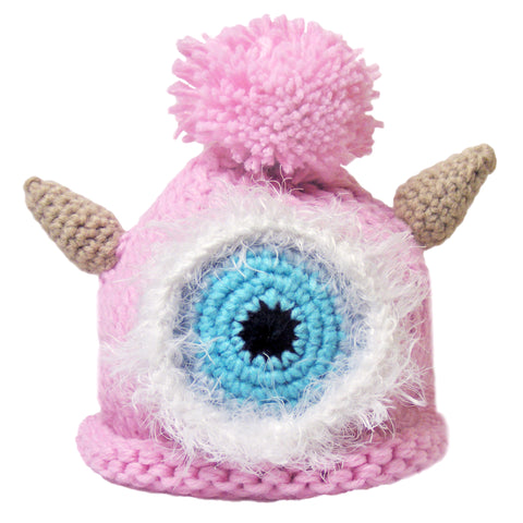 Adorable pink baby monster hat with one eye, two horns, and a playful pom-pom, showcased against a clean white background - a whimsical and charming accessory for little ones.