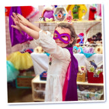 Young girl confidently wearing a superhero cape and matching mask, striking a dynamic pose with boundless energy and imagination.