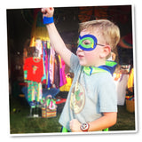 Young boy confidently wearing a superhero cape and matching mask, striking a dynamic pose with boundless energy and imagination.